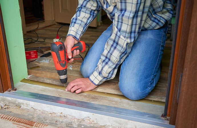 Professional worker making a threshold for carpet