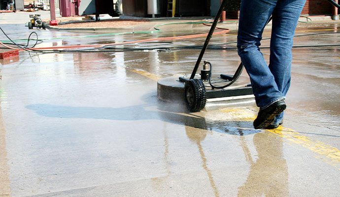 Cleaning concrete floor Person cleaning concrete floor