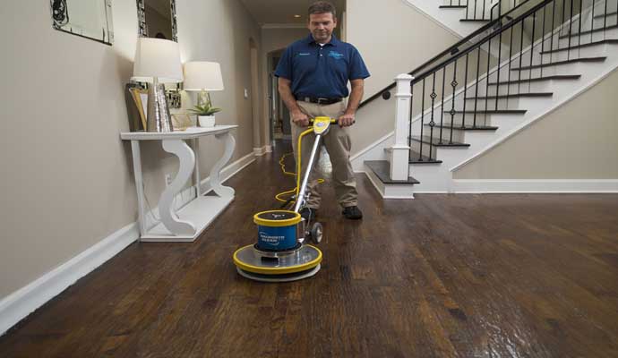 Wood floor cleaning using a machine