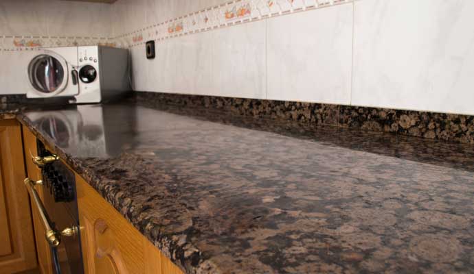 A clean, well-kept granite countertop in a kitchen