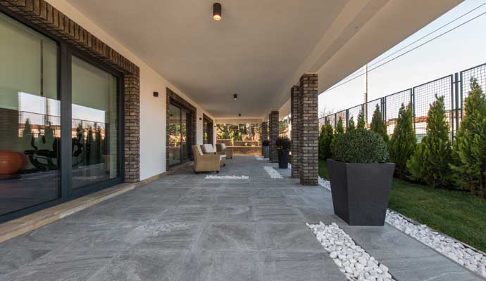 Outdoor patio with clean, gray stone floor